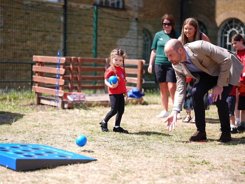 Prince William playing a game of bowls with pupils during a visit to the Ysgol Gymraeg Llundain (The London Welsh School).