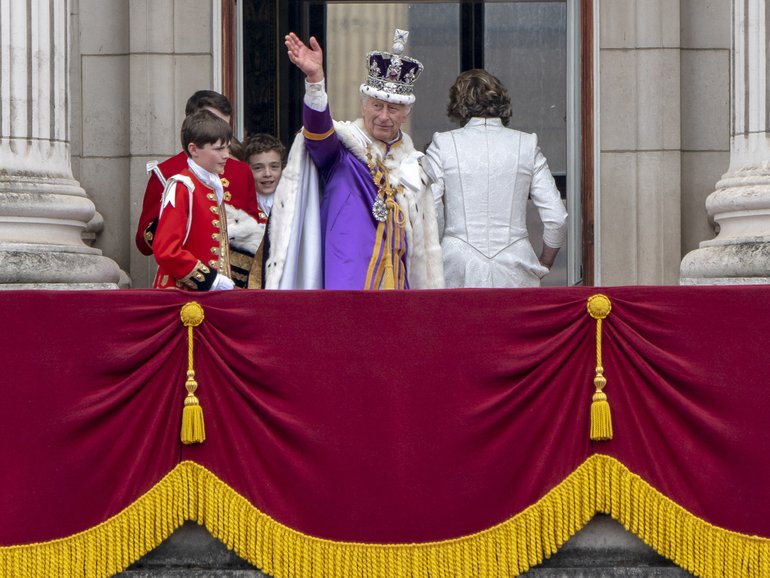 King Charles III, Queen Camilla and members of the royal family wave from the Buckingham Palace balcony after his coronation in London on May 6, 2023.  