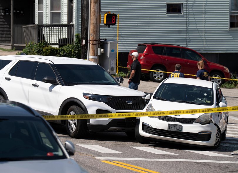 A Kia sedan reportedly driven by the victim of a fatal shooting can be seen with four bullet holes in the windshield at the scene.