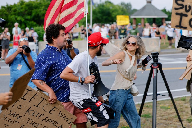 A counterprotester wearing a MAGA hat stands facing a woman as people protest against U.S. Immigration and Customs Enforcement (ICE) at Mechanics Park, after a shooting involving ICE, in Biddeford, Maine, U.S., July 13, 2026. REUTERS/CJ Gunther Picture: CJ Gunther