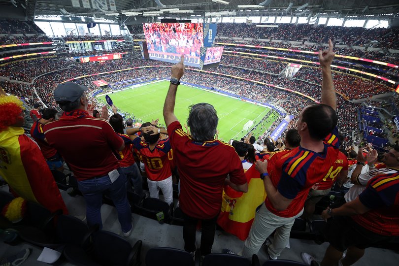 Spain fans celebrating in the stands.