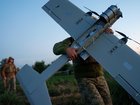 A Ukrainian serviceman of K-2 brigade of the Unmanned Systems Forces carries a midrange drone on takeoff position before flying towards Russian positions at the frontline in Donetsk region, Ukraine, Monday, June 22, 2026. (AP Photo/Evgeniy Maloletka) Evgeniy Maloletka