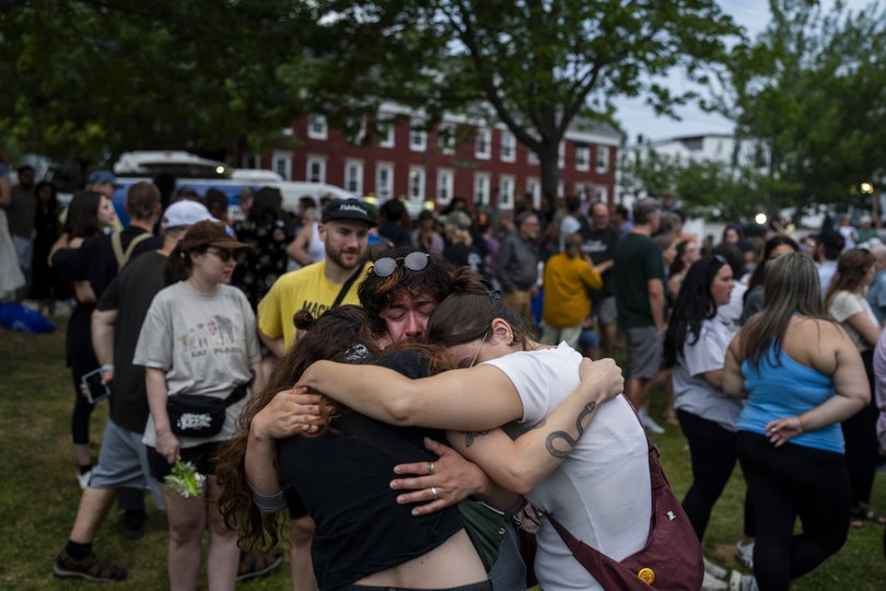 Mourners embrace while attending a vigil in Mechanics Park in Biddeford, Maine, on Monday, July 13, 2026, for a man who was shot and killed by a federal immigration agent on Monday morning. The fatal shooting in Biddeford was the second in a week involving an Immigration and Customs Enforcement agent firing into a vehicle. (Christopher Capozziello/The New York Times)