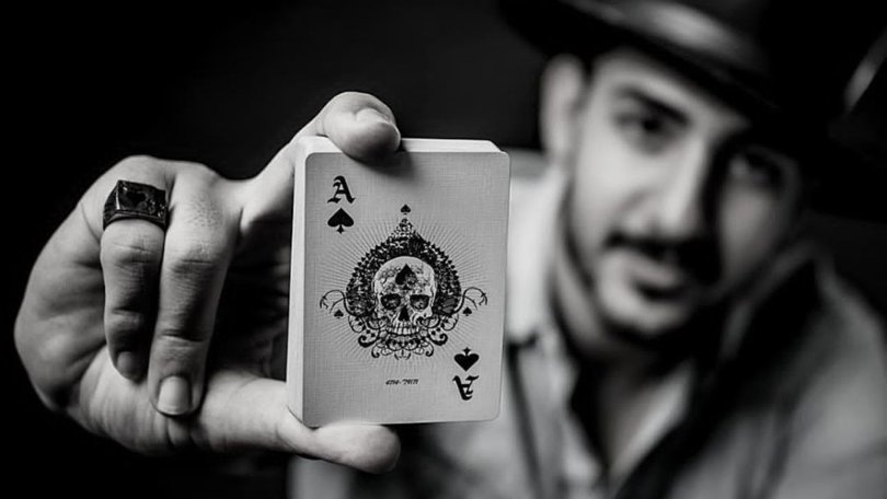 Daniel Hidden performs one of his signature card tricks. His passion began in Iran, where playing cards were forbidden.