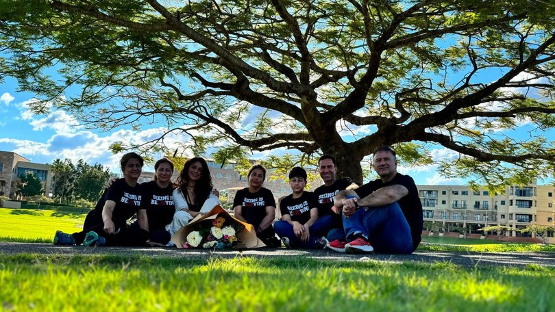 Hidden’s loved ones paused beneath a tree to reflect on the life of the Gold Coast magician before continuing their farewell.