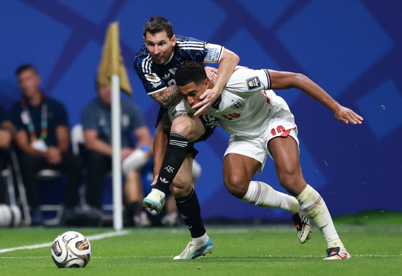 Jude Bellingham and Lionel Messi doing battle.