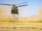 This US Army handout photo shows three US Army CH-47 Chinook helicopters preparing to land in the Middle East during routine flight operations.