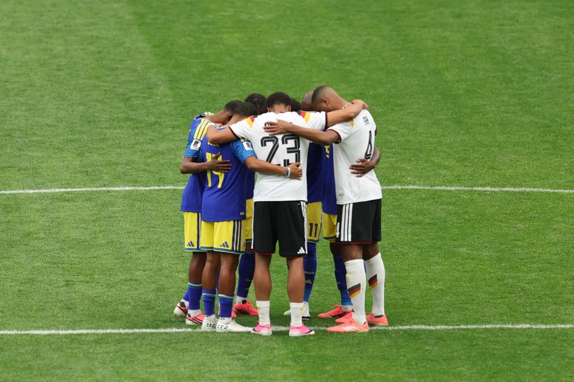 Players of Germany and Curacao huddle after the FIFA World Cup 2026.