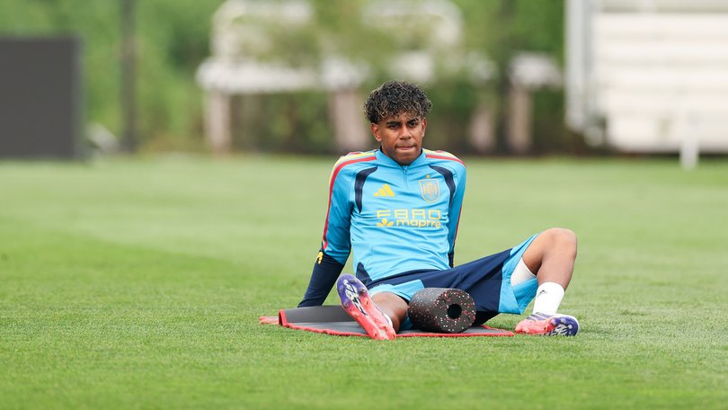 Lamine Yamal looks on during training.