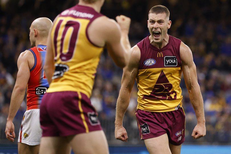 Josh Dunkley of the Lions celebrates after a goal.