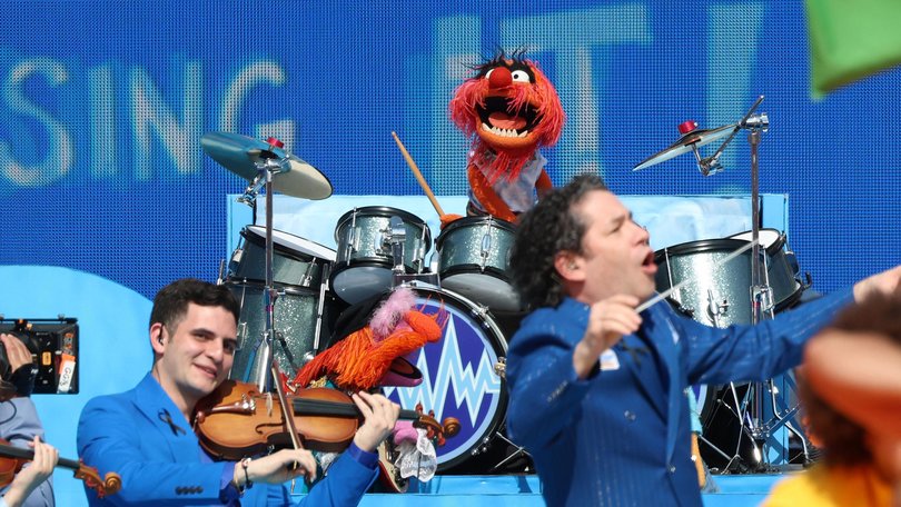Gustavo Dudamel of the New York Philharmonic and Animal of The Muppets perform at the World Cup half-time show/