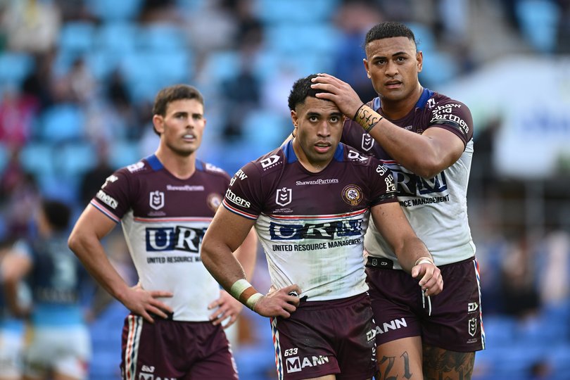 Tolutau Koula of the Sea Eagles is congratulated by team mates after scoring a try.