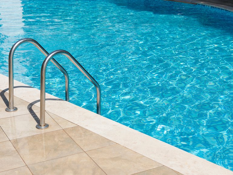 A five-year-old boy has been left fighting for his life after he was poisoned by chlorine while swimming in a public pool.