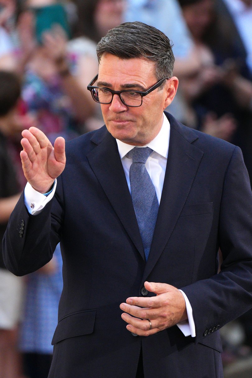 Andy Burnham gestures as he speaks to the media outside Downing Street.