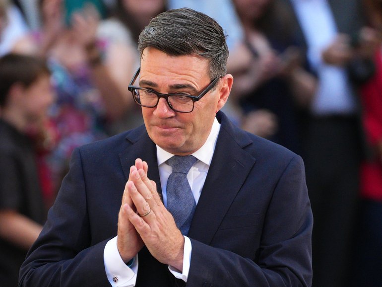 The new British Prime Minister and leader of the Labour Party, Andy Burnham, gestures as he speaks to the media as he arrives at 10 Downing Street.