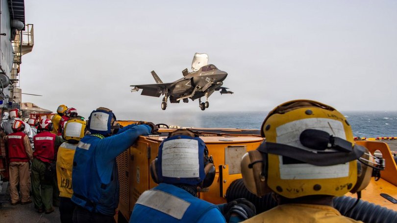 US service members aboard amphibious assault ship USS Boxer (LHD 4) support flight operations from the Arabian Sea.