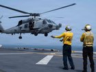 US service members aboard amphibious assault ship USS Boxer support flight operations as CENTCOM enforces the naval blockade against Iran. 