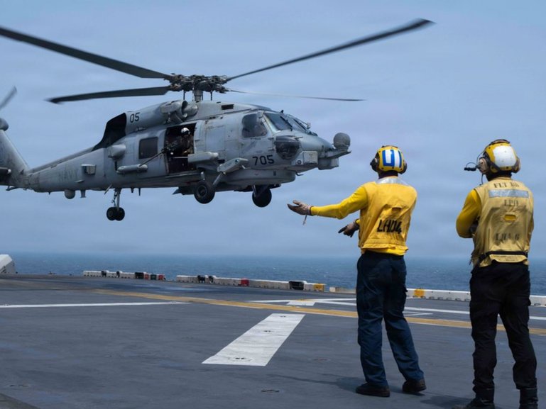 US service members aboard amphibious assault ship USS Boxer support flight operations as CENTCOM enforces the naval blockade against Iran. 