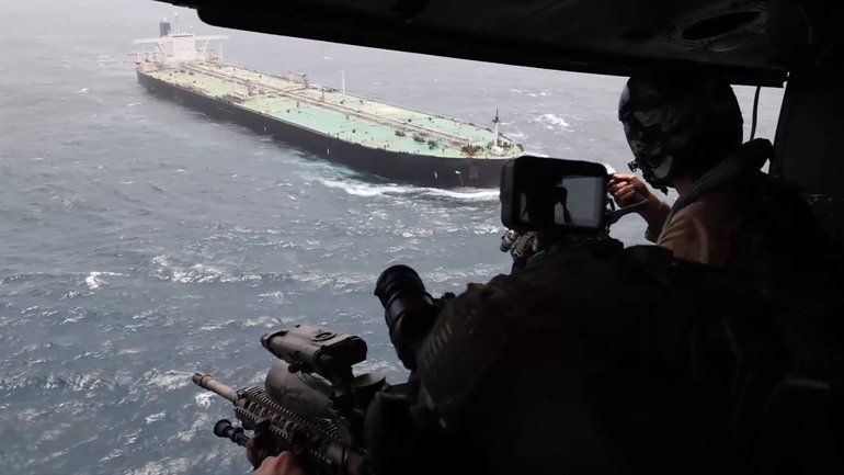 Image released by US Central Command to with the caption 'Every operational success in the Middle East begins and ends with service members focused on their missions, including the U.S. blockade against Iran. As of July 21, U.S. forces have redirected 8 commercial vessels and disabled 1 to fully enforce the blockade.' 