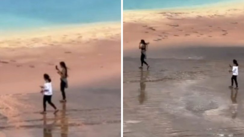 Two tourists have been filmed waking across the protected thermal area surrounding the largest hot spring in the US, prompting widespread criticism after footage of the act spread online.