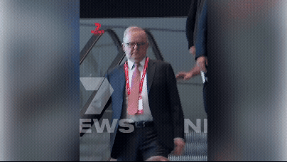 Prime Minister stumbles on escalator 