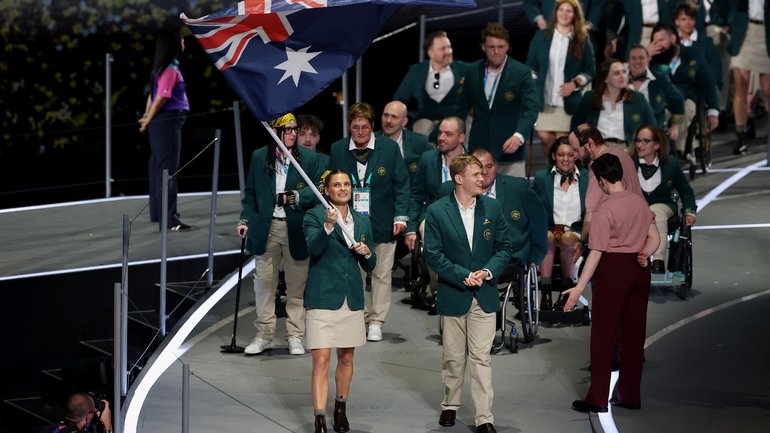 Nina Kennedy para-swimming star Tim Hodge lead the team out for the Comm Games Opening Ceremony in Glasgow