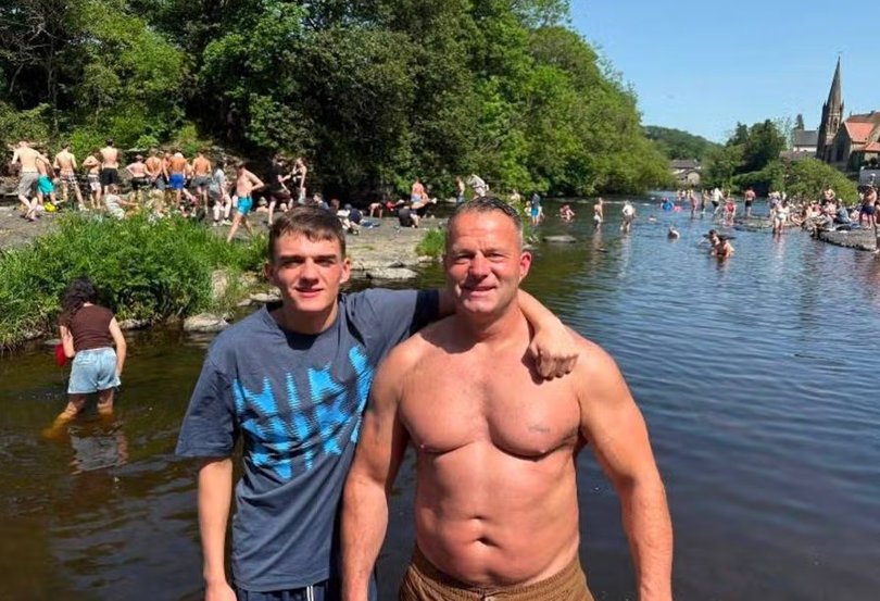 Andrew Tinsley, who dies after jumping from a bridge in Wales, with one of his children.