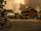 Smoke rises behind houses near the tourist town of Lege-Cap-Ferret in France. 