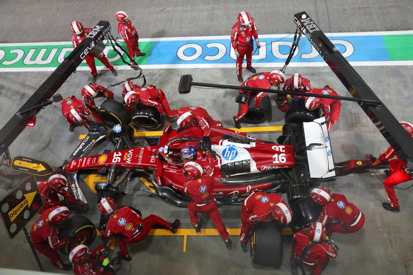 A Formula One pit crew in action.