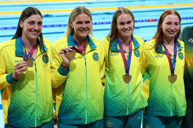Gold medalists Meg Harris, Shayna Jack, Alex Perkins and Mollie O'Callaghan of Team Australia pose for a photo after the medal ceremony for the Women's 4 x 100m Freestyle Relay Final.