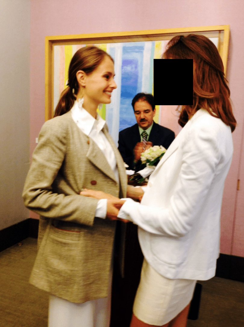 An undated image provided by the Department of Justice shows Dr. Karyna Shuliak, left, marrying a woman in 2013 whose face has been obscured by The New York Times because she has said that she is a victim of Jeffery Epstein. 