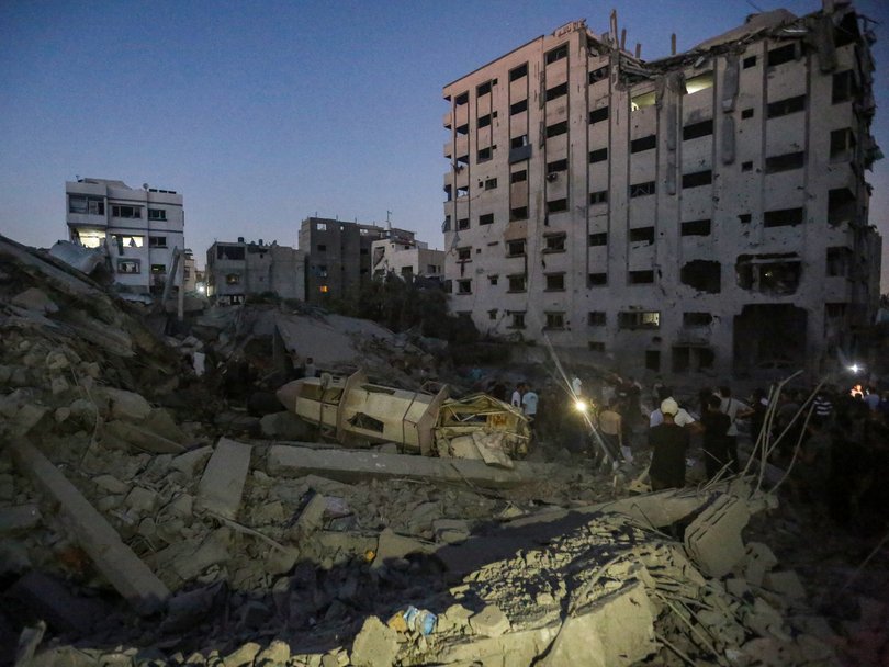 People inspect the damage after the Israeli air strikes on Tuesday.