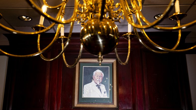 A painted portrait of Colonel Sanders hangs above a mantle in the event hall at Claudia Sanders Dinner House.