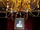 A painted portrait of Colonel Sanders hangs above a mantle in the event hall at Claudia Sanders Dinner House.