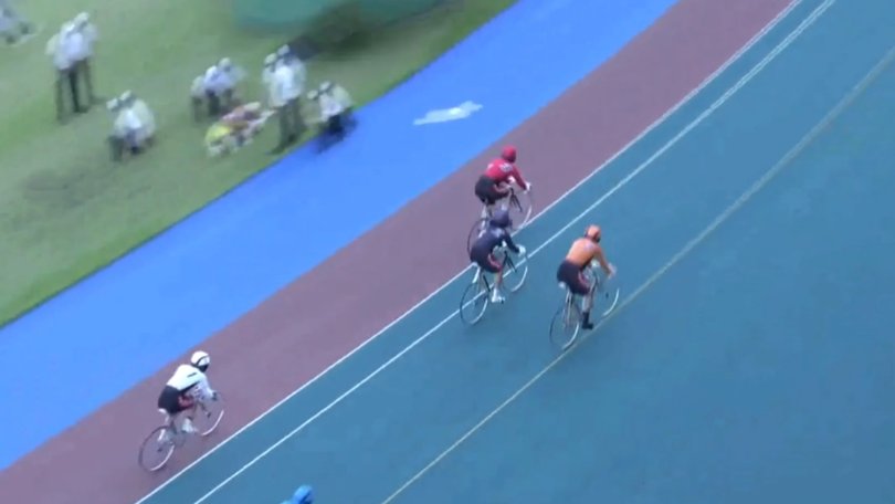 Richardson lays on the side of the track as Suzuki (white, bottom left) finishes the race.