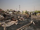 Iraqis inspect damaged structures at the site of an airstrike on a Popular Mobilization Forces base in Mosul, Iraq.