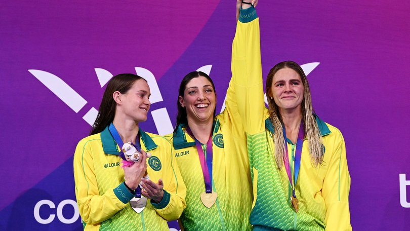 A beaming Meg Harris on the podium with a tearful Shayna Jack and Meg Harris.