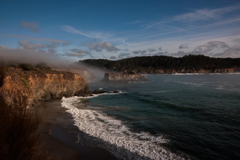 In Mendocino, walking trails trace the cliffs where waves surge against the rocks below.