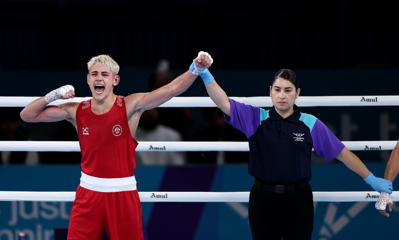 Jye Dixon of Team Australia has his hand raised following victory.