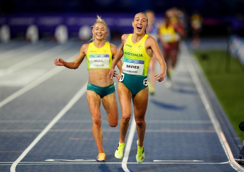 Rose Davies (front) crossing the finish line in first place ahead of Jessica Hull.