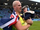 Matt Denny celebrated with son Roman after winning gold in Glasgow. (Joel Carrett/AAP PHOTOS)
