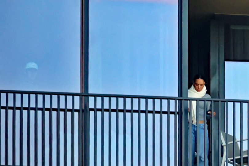 Lachie Neale & Emma Field on his balcony.