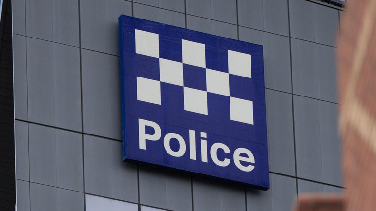 The 21-year-old was restrained by cabin crew until Australian Federal Police officers reached the arrivals gate. 