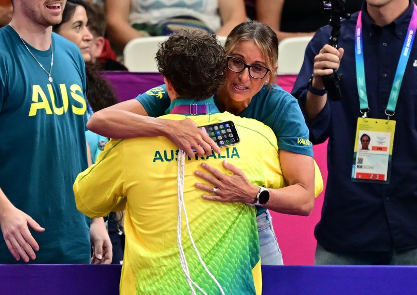 Gold medallist Kai Taylor receives a hug from his mother Hayley Lewis.