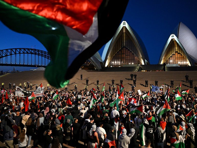 Participants of a Free Palestine rally react outside the Sydney Opera House in Sydney, Monday, October 9, 2023. Israel has pounded the Palestinian enclave of Gaza, killing hundreds of people in retaliation for one of the bloodiest attacks in its history when Islamist group Hamas killed 700 Israelis and abducted dozens more.