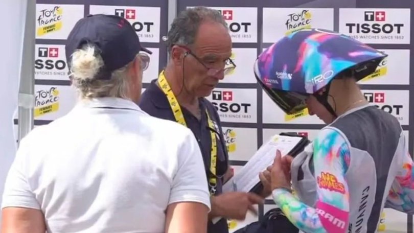 Officials conduct chest checks at the Tour de France Femmes.