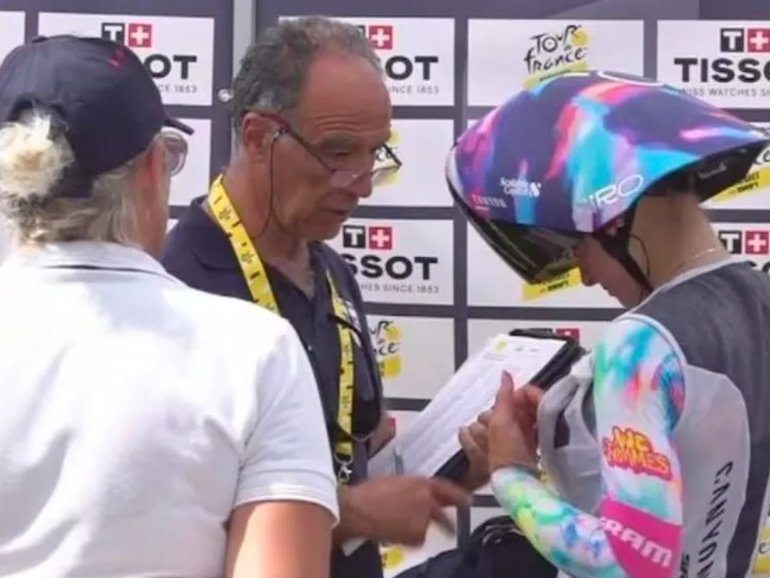 Officials conduct chest checks at the Tour de France Femmes.