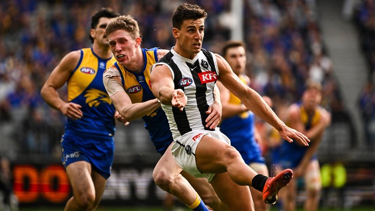 Nick Daicos gets a kick away under pressure.