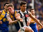 Nick Daicos gets a kick away under pressure.