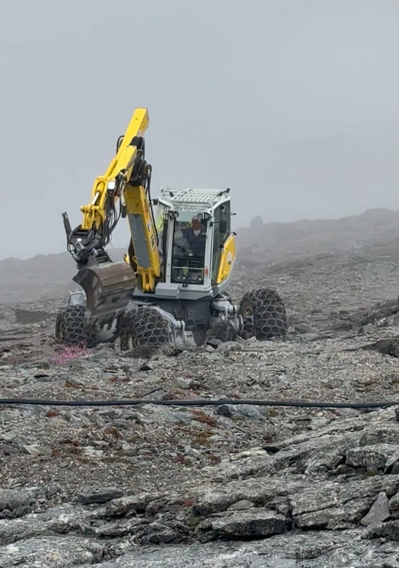 A digger prepares an area for exploration drilling at Tanbreez Mining’s rare earths deposit in Greenland.